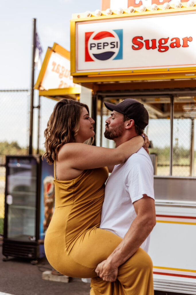 A couple in front of a carnival food truck