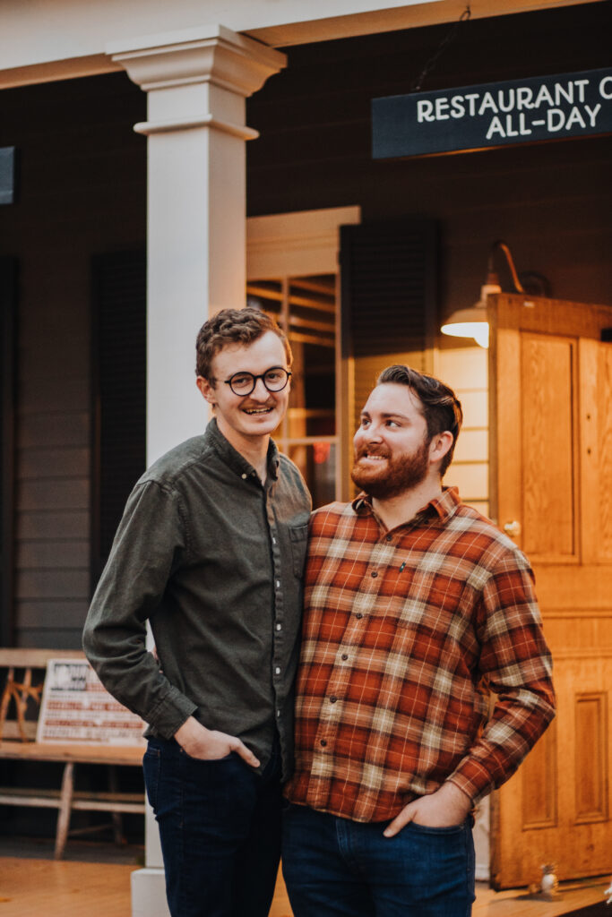 A gay couple smiling at each other