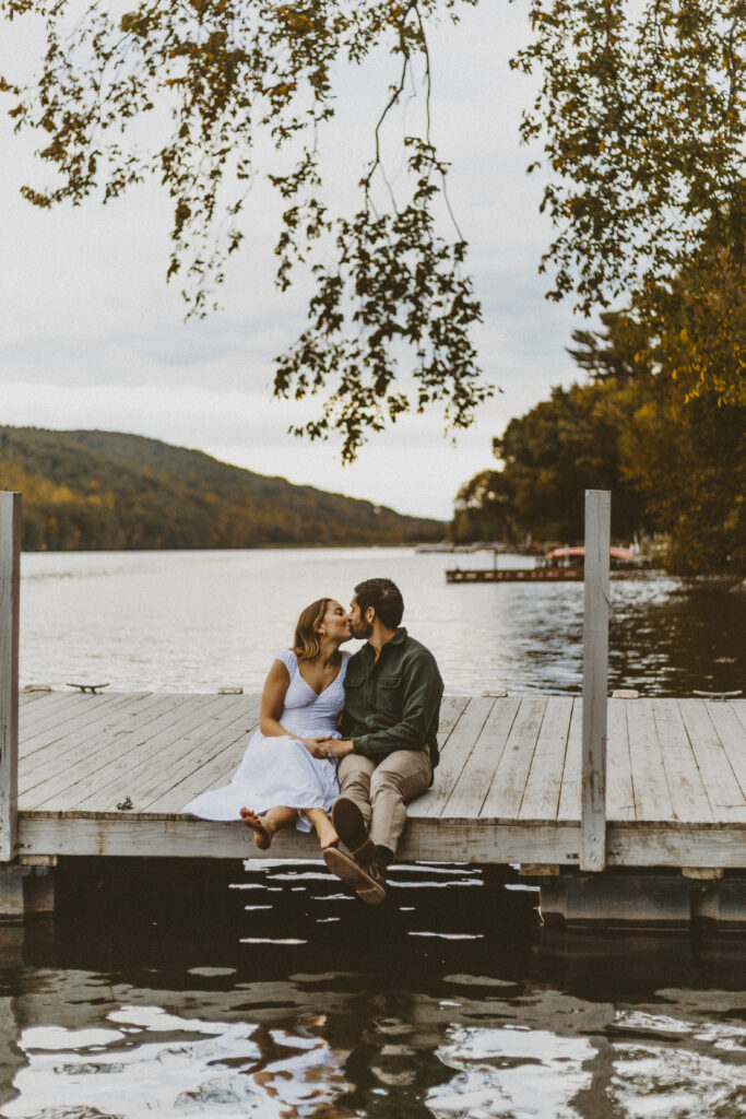 A couple sitting on a pier on Candlewood Lake in New Milford CT